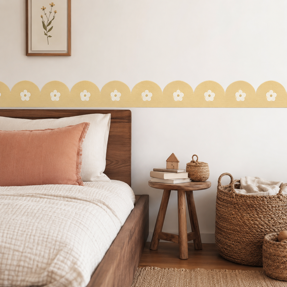 Buttercream yellow daisy scalloped peel-and-stick wallpaper border above a wooden bed with cream bedding and a peach cushion.